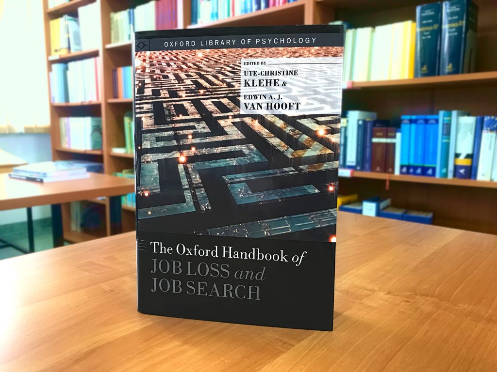 książka ustawiona na blacie bibliotecznego biurka